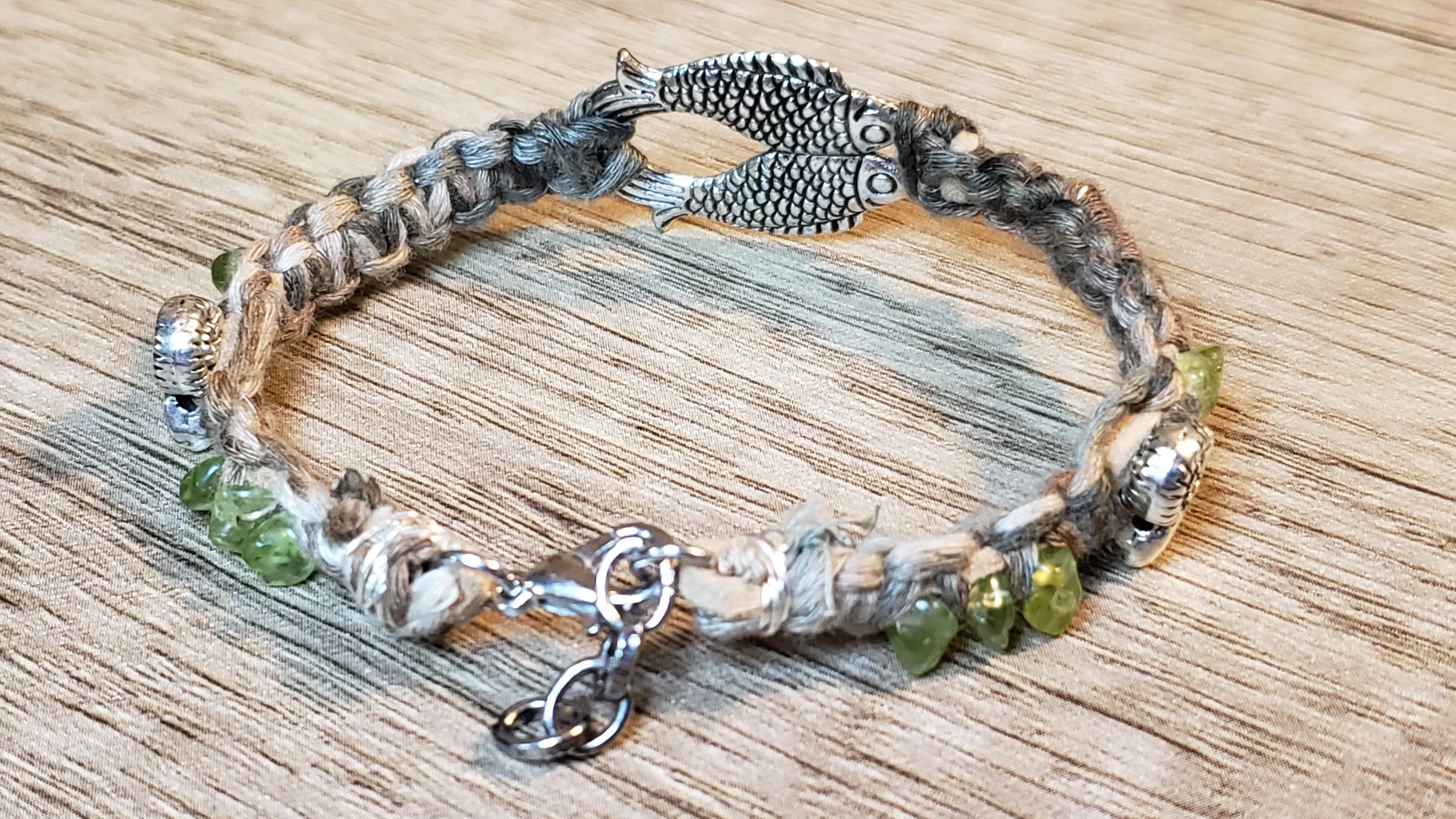 Silver Plated Fish & Shell with Heibi Peridot Accent Bracelet. Cotton Cording, Adjustable Chain & Lobster Claw Clasp 
 
